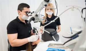 Dentists working out a patient's dental abscess.